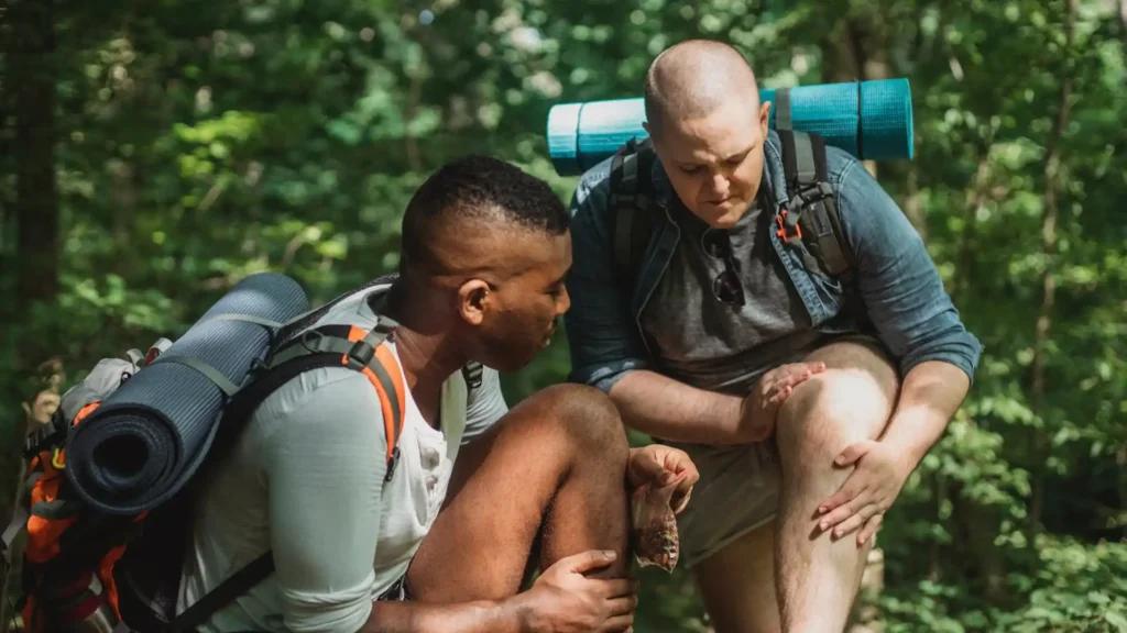 two men looking at their swollen knees