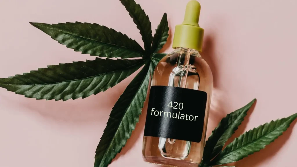 Fresh cannabis leaves with a dropper bottle of cannabis terpenes for pain relief and inflammation