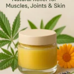 A jar of cannabis-infused balm with a lid and fresh cannabis leaves, lavender and marigold.