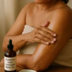 A woman applying pumpkin seed and cannabis body oil to her arm.
