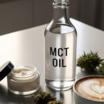 A bottle of MCT Oil next to a cup of coffee and cannabis.