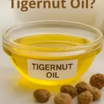 A small bowl of Tigernut oil with dried tigernuts alongside.