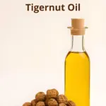 A bottle of Tigernut oil with chufa nuts alongside.