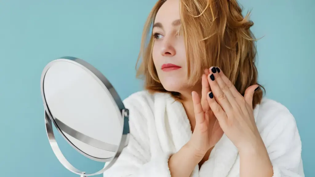 A woman using meadowfoam seed oil for skin and hair.