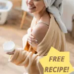 A woman in bathroom towels applying shea butter to her shoulder.